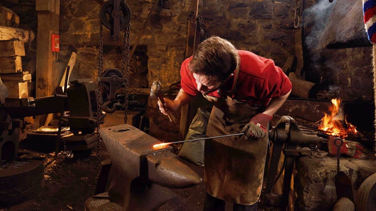 Shaping metal on the anvil at Finch Foundry, Devon